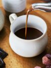 Pouring hot chocolate from a kettle food photography