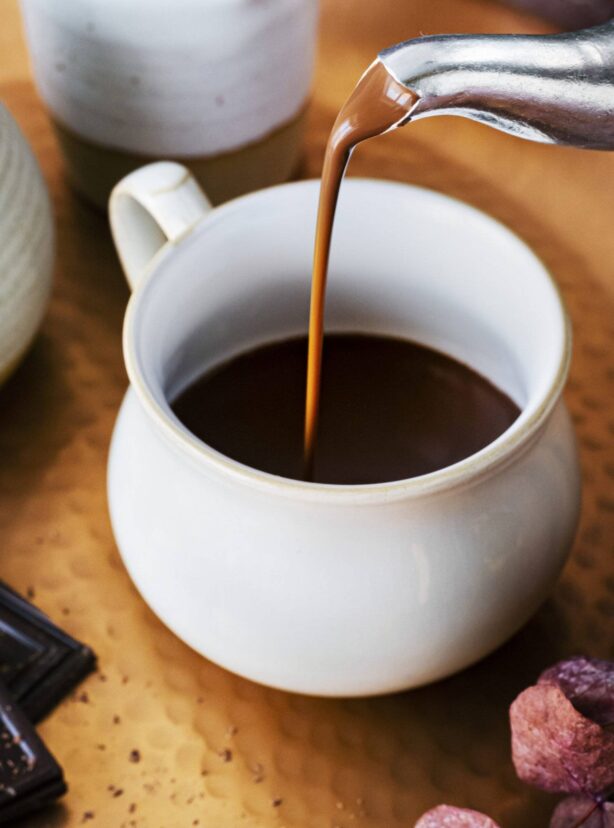 Pouring hot chocolate from a kettle food photography Pouring hot chocolate from a kettle food photography